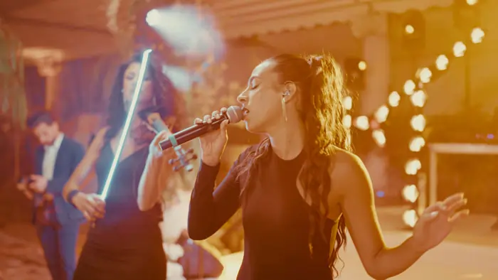 A soul and swing singer performing at a wedding, backed by musicians | Mikevents
